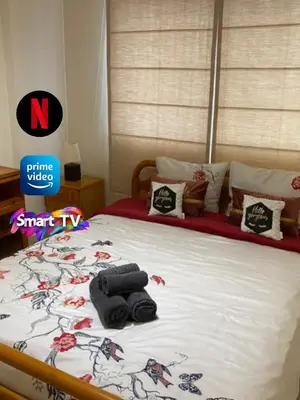 a bed with towels and pillows on top of it at Larnaca Comfort Rooms With Smart TV & Netflix in Larnaka