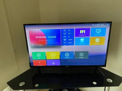 a flat screen tv sitting on a black stand at Larnaca Comfort Rooms With Smart TV & Netflix in Larnaka
