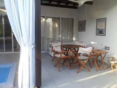 a dining room with a table and chairs at Yialos Holiday Apartments in Pervolia