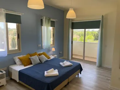 a bedroom with a bed with two towels on it at Protaras Tennis and Country Club in Protaras