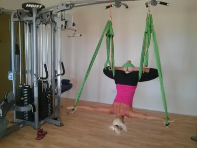 a woman is on a swing in a gym at Protaras Tennis and Country Club in Protaras