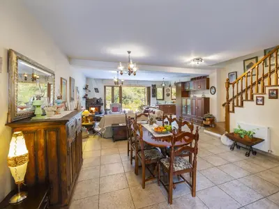 a kitchen and dining room with a table and chairs at Troodos Riverside Cottage in Kato Amiandos