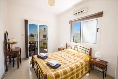 a bedroom with a bed and a window at Carilisto Villas Big 4 Bedrooms in Center of Ayia Napa in Ayia Napa