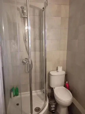 a bathroom with a toilet and a glass shower at Studio in the center of Nicosia in Nicosia