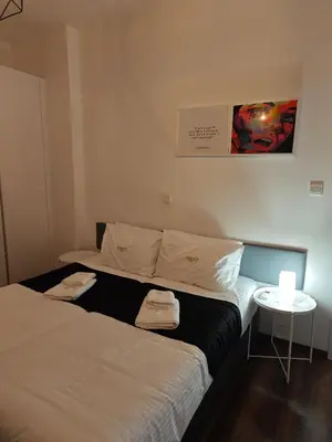 a bedroom with two beds and a small table at Maximos Luxury Villa Monagri Limassol in Limassol