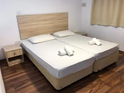 a bedroom with a bed with two towels on it at Cozy Loft Apartment in Ayia Napa