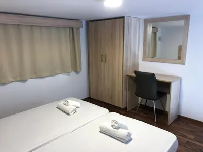a bedroom with a bed and a desk and a chair at Cozy Loft Apartment 2 in Ayia Napa