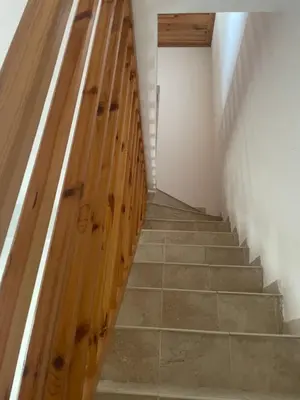 a hallway with wooden stairs in a room at Omodos Katoi Holiday Homes in Omodos