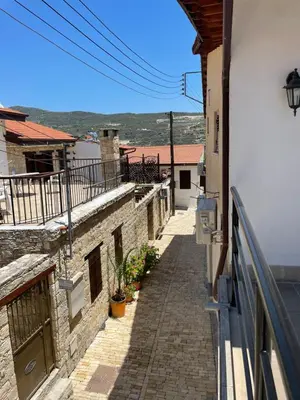 a small alley way in a building with a balcony at Omodos Katoi Holiday Homes in Omodos