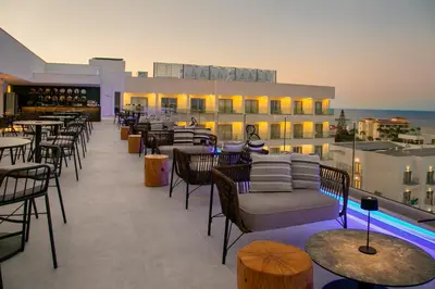 a rooftop bar with tables and chairs on a building at Atlantica Aqua Blue in Protaras