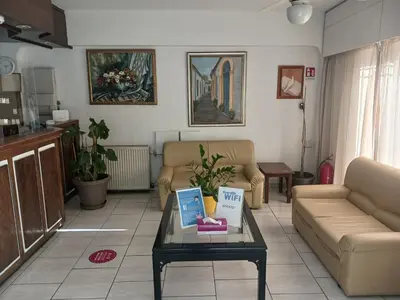 a living room with a couch and a table at Denis Hotel in Nicosia