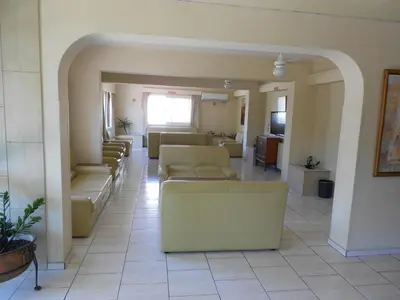 a living room with couches and chairs in a room at Denis Hotel in Nicosia