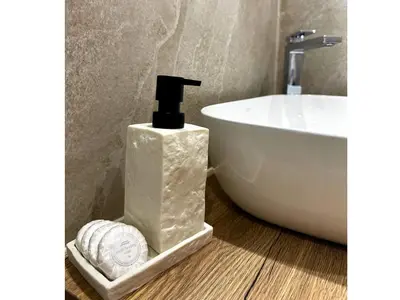 a bathroom with a bottle of soap and a sink at Denis Hotel in Nicosia