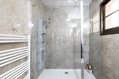 a bathroom with a shower and a bath tub at Pinecone Platres - 3 Units in Platres