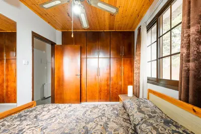 a bedroom with a bed and a wooden cabinet at Pinecone Platres - 3 Units in Platres