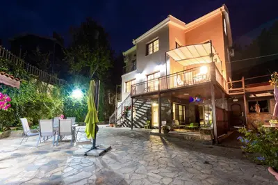 a patio in front of a building at night at Pinecone Platres - 3 Units in Platres