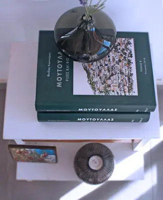 two books on a table with a clock and a cd at Laoni Guest House in Moutoullas, Marathasa in Limassol