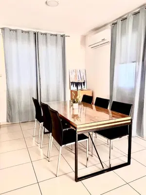 a dining room with a wooden table and chairs at Dafni Villa Ekaterina 3 bdrm in Protaras