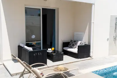 a living room with a couch and a pool at Dafni Villa Ekaterina 3 bdrm in Protaras