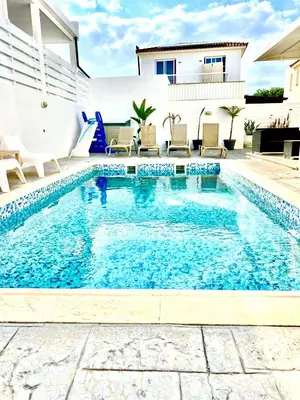 a swimming pool with blue water in a house at Dafni Villa Ekaterina 3 bdrm in Protaras