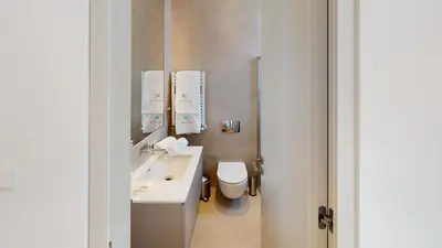 a bathroom with a white sink and a toilet at Periyiali Konnos Villas Beach Resort in Protaras
