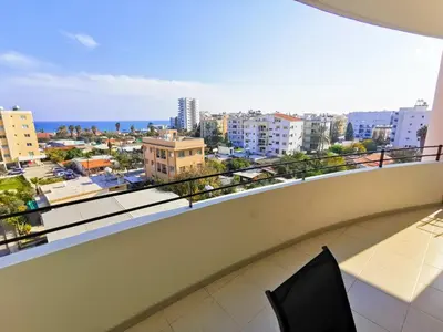 a balcony with a view of a city at License to Chill Apartment in Larnaka