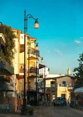 a city street with buildings and a street light at LIV URBAN Suites in Larnaka