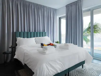 a bedroom with a bed with a bowl of fruit on it at LIV URBAN Suites in Larnaka