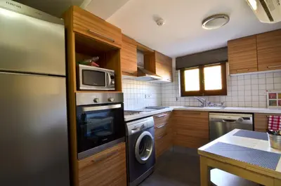 a kitchen with a refrigerator and a microwave at To Kastri in Kalopanayiotis