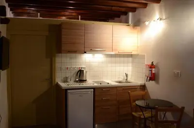 a small kitchen with a stove and a sink at To Kastri in Kalopanayiotis