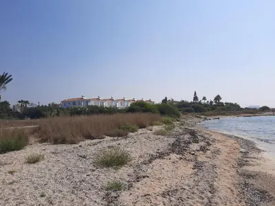 a sandy beach with houses in the background at Villa Anastassia in Ayia Napa