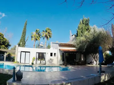a house with a swimming pool in front of it at The Stone Villa in Pissouri