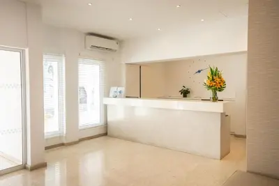 a kitchen with a counter with a vase of flowers at Liquid Hotel Apartments in Ayia Napa