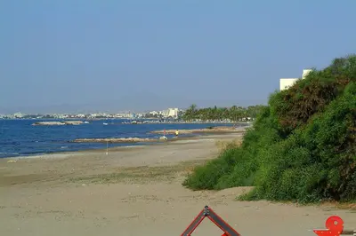 a beach with a hazard sign on the sand at Sunbay Apartments in Pyla