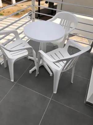 a white table and two white chairs on a porch at Katalimata Court in Ayia Napa