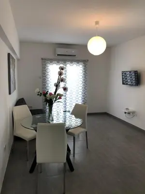 a dining room with a table and chairs at Katalimata Court in Ayia Napa