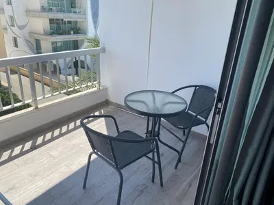 a balcony with two chairs and a table on a balcony at Greco 1 Bedroom Apartment in Limassol