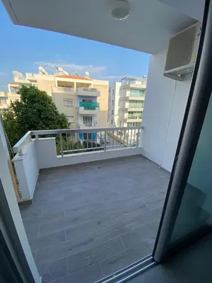 a balcony with a view of a building at Greco 1 Bedroom Apartment in Limassol