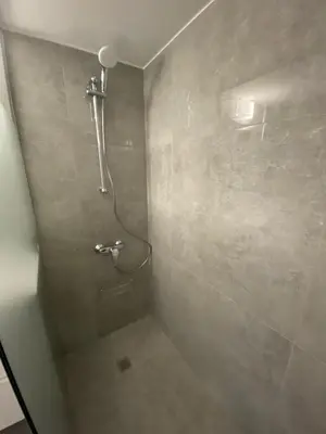 a bathroom with a shower with a shower head at Greco 1 Bedroom Apartment in Limassol