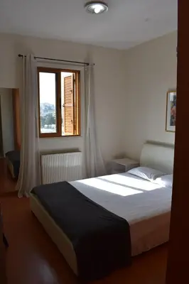a bedroom with a large bed with a window at Klimentos Flat 59 in Nicosia