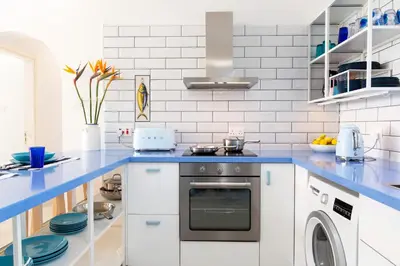 a kitchen with a blue counter top and a dishwasher at Zima Blue in Zygi