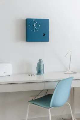 a desk with a blue clock and a blue chair at Zima Blue in Zygi