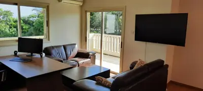 a living room with couches and a flat screen tv at Villa Larnaca Bay Resort in Voroklini