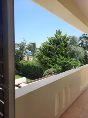 a balcony with a view of trees and bushes at Villa Larnaca Bay Resort in Voroklini