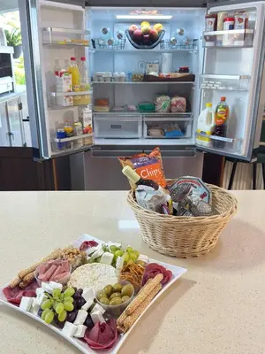 an open refrigerator with a plate of food and a basket of food at Kasparis View Residence in Pano Lefkara
