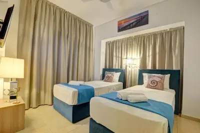a hotel room with two beds and a lamp at SunnyVillas: 4BR Villa☆Private Pool + Jacuzzi - Villa Amelie in Protaras