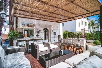 an outdoor patio with couches and a table at SunnyVillas: 4BR Villa☆Private Pool + Jacuzzi - Villa Amelie in Protaras