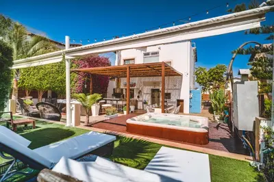 a backyard with a hot tub and a house at SunnyVillas: 4BR Villa☆Private Pool + Jacuzzi - Villa Amelie in Protaras