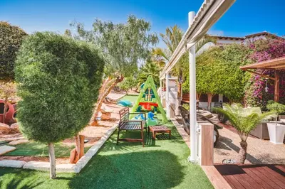 a backyard with a playground with a slide at SunnyVillas: 4BR Villa☆Private Pool + Jacuzzi - Villa Amelie in Protaras