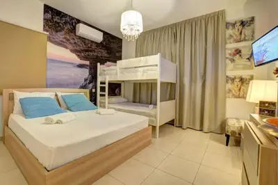a bedroom with a bunk bed and a television at SunnyVillas: 4BR Villa☆Private Pool + Jacuzzi - Villa Amelie in Protaras